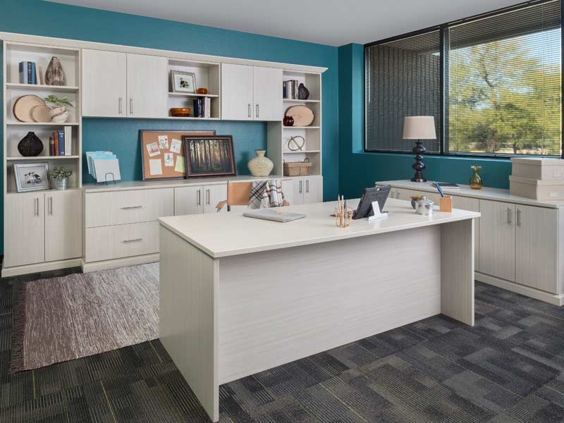 Custom home office built-ins with white cabinetry, open shelving and integrated desk workspace
